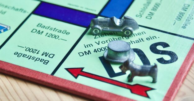 Ein Monopoly-Spielbrett als Metapher für den Unterschied zwischen Immobilieneigentümern und Mietern | Kaufen statt Mieten